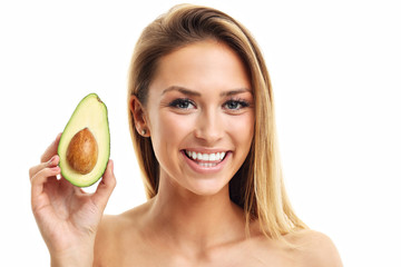 Portrait of attractive adult woman with avocado isolated over white background