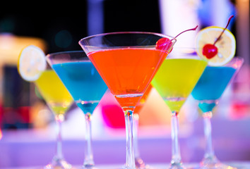 Group of colorful cocktail in martini glasses.