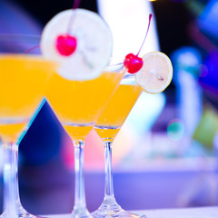 Group of colorful cocktail in martini glasses.