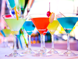 Group of colorful cocktail in martini glasses.