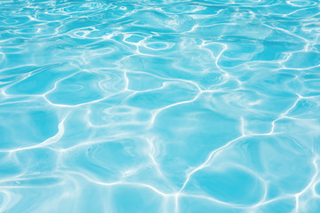 Obraz na płótnie Canvas Blue and bright ripple water and surface in swimming pool , Beautiful motion gentle wave in pool