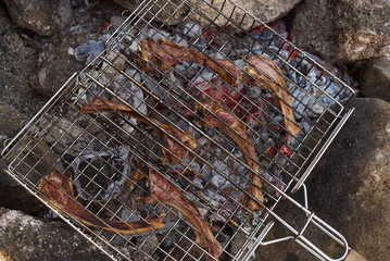 Close up of Cooking delicious barbecued lamb ribs . Lamb ribs at outdoors grill. Summer Weekend and party concept.