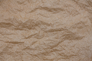 Fototapeta premium Wrinkled kraft paper. Top view brown crumpled paper background texture