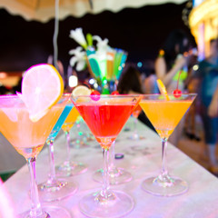 Group of colorful cocktail in martini glasses.