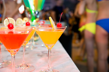 Group of colorful cocktail in martini glasses.