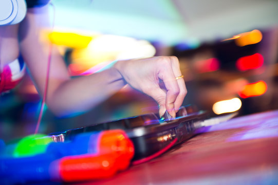 Dj mixing in nightclub at party.