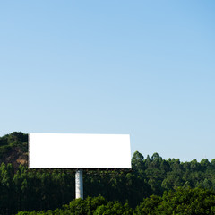 Blank billboard against blue sky.