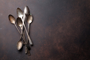 Old vintage spoons on stone table