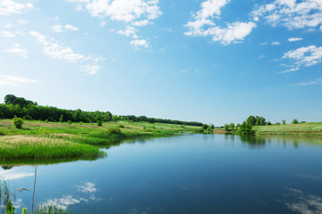 Fototapeta premium Landscape with pond and hills