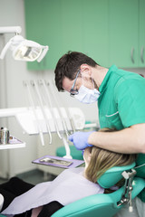 Young woman controls her teeth at the dentist