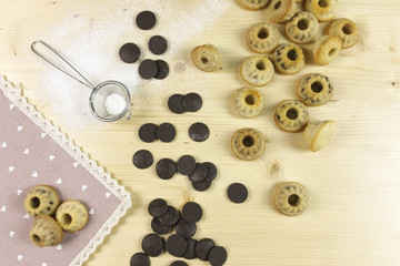 Small donuts on wood background - top view