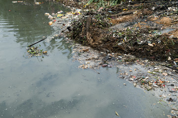Water pollution in river with trash.