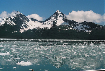 Ice Chunks Floating in Ocean near Mountains of Seward Alaska