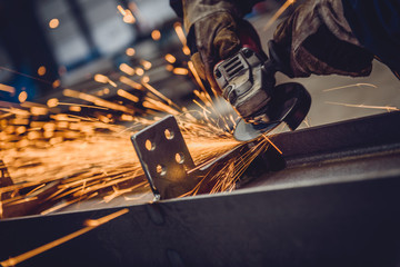 Worker Using Angle Grinder