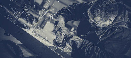 Worker Using Angle Grinder