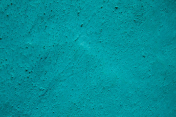 Turquoise dotted grunge textured wall