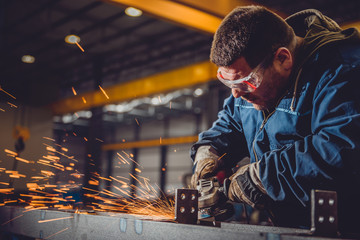 Worker Using Angle Grinder