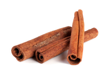 three cinnamon sticks isolated on white background