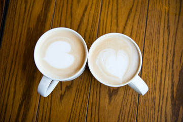 two cups of coffee cappuccino with heart shape