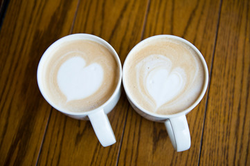 two cups of coffee cappuccino with heart shape