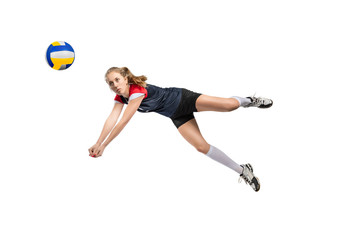 Female volleyball player hitting the ball