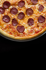 Pizza with salami on a white plate