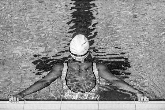 Rear view of female swimmer on poolside