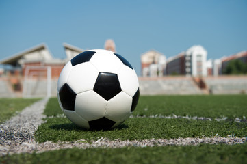 soccer ball on stadium grass line.