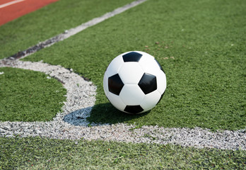 soccer ball on stadium grass line.
