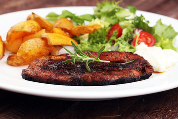 Grilled steaks, baked potatoes and salad