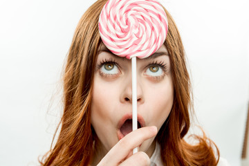 round lollipop over the eyes of a woman