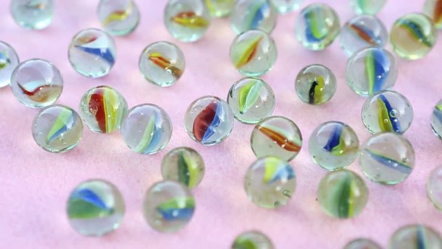 group of marbles on rotating pink table
