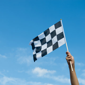 checkered race flag in hand.