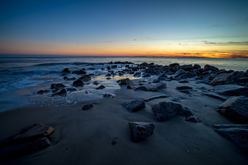Waves and a jetty at sunset in the Atlantic Ocean at Edisto beach south carolina