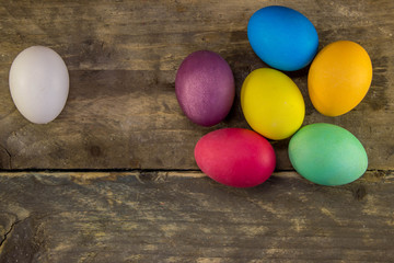 Colorful easter eggs on rustic wooden table
