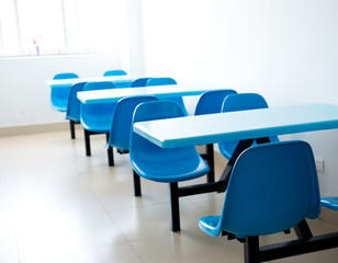 Clean cafeteria with empty seats and tables.
