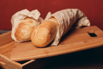 loaves packed in paper bags lie on the board