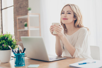 Happy pretty cute woman working with computer enjoying coffee