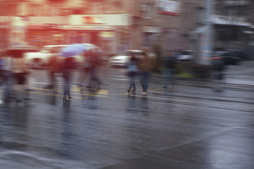 people walking rush hour in the rain