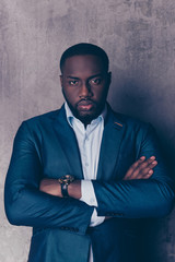 Portrait of successful  handsome afroamerican man in stylish suit crossed hands