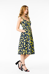 Young elegant female in light summer dress, over white background