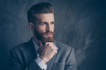 Photo sur Plexiglas Salon de coiffure portrait of handsome stylish young man with mustache, beard and beautiful hairstyle keep calm and think while hold beard and chin with hands