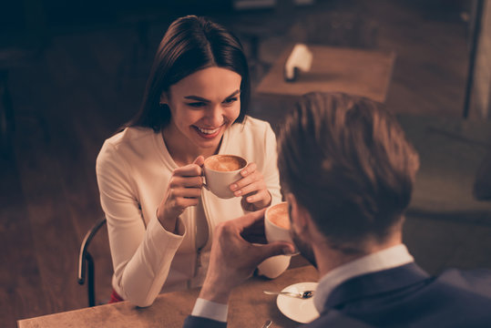 Cheerful romantic couple sitting in a cafe with coffee
