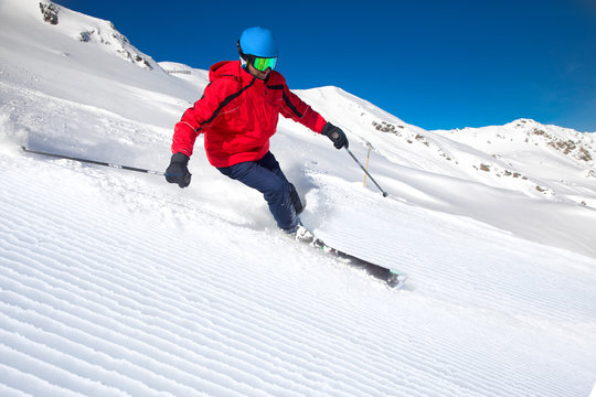 Man skiing on the prepared slope with fresh new powder snow in Alps