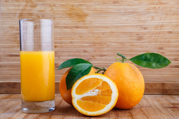 Fresh orange juice on wooden table