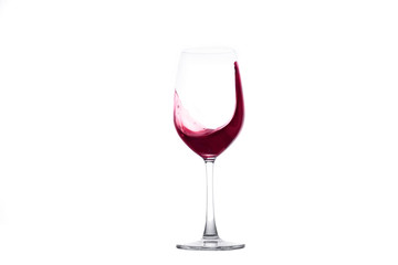 Red wine splashing out of a wineglass 
