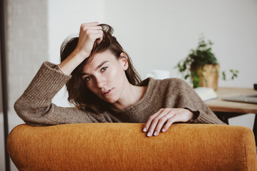 indoor portrait of beautiful feminine thoughtful young women alone in the room.
