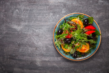 Fresh Green mix Salad with Vegetables, Tomatoes and Microgreen.Leaves Of Spinach,Arugula,Romaine,Lettuce.Concept of Healthy Food.Vegetarian.Copy space for Text. selective focus.