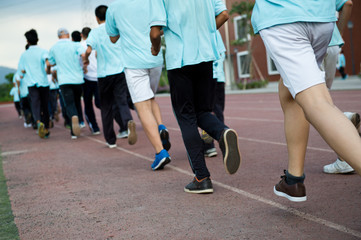 Group of students running on a racing track.