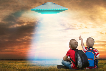 Two younger brother looking at the unidentified flying object that appeared in the sky. © Denis